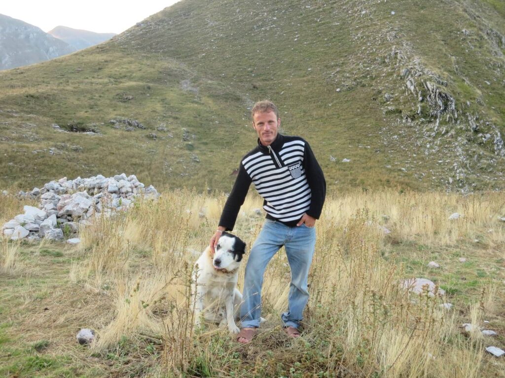 Albanian shepherd with his fierce sheep guard dog
