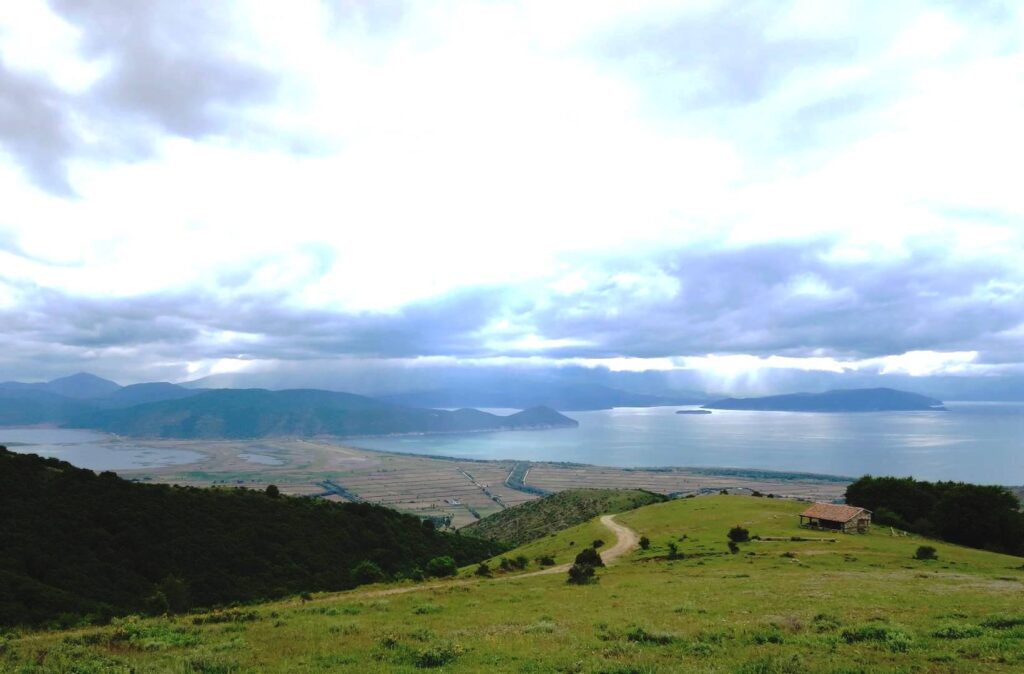View of both Prespa lakes with causeway between, and storm clouds