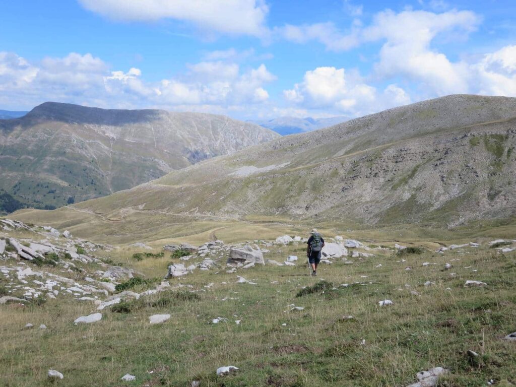 Lone hiker coming over the wild bare ridge of Kakarditsa pass